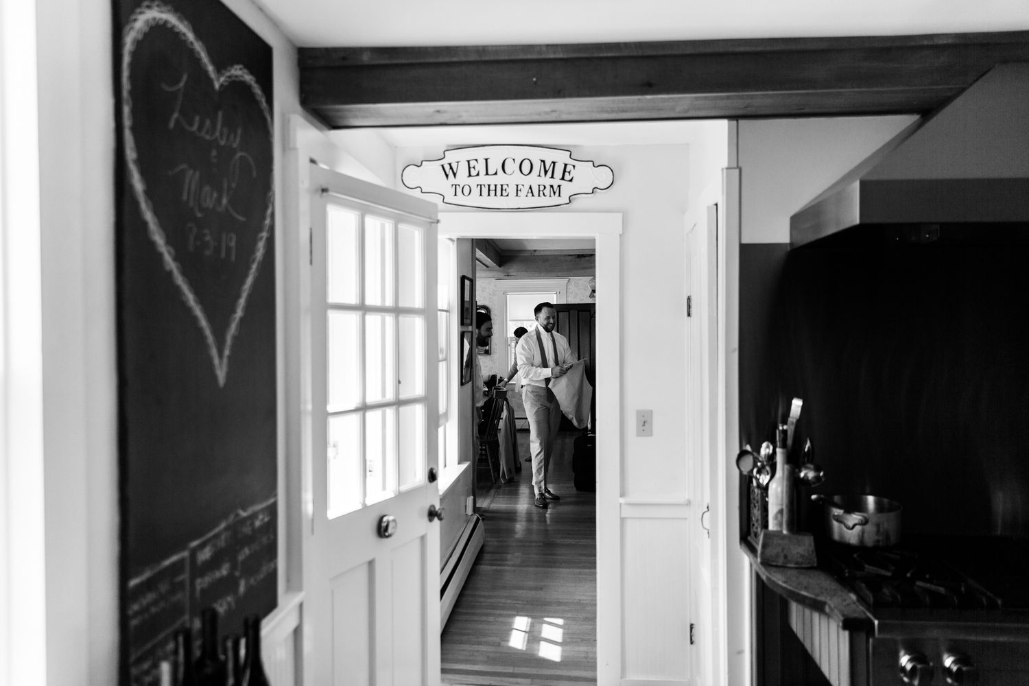 Interior view of a rustic room with welcome sign and white doorway.
