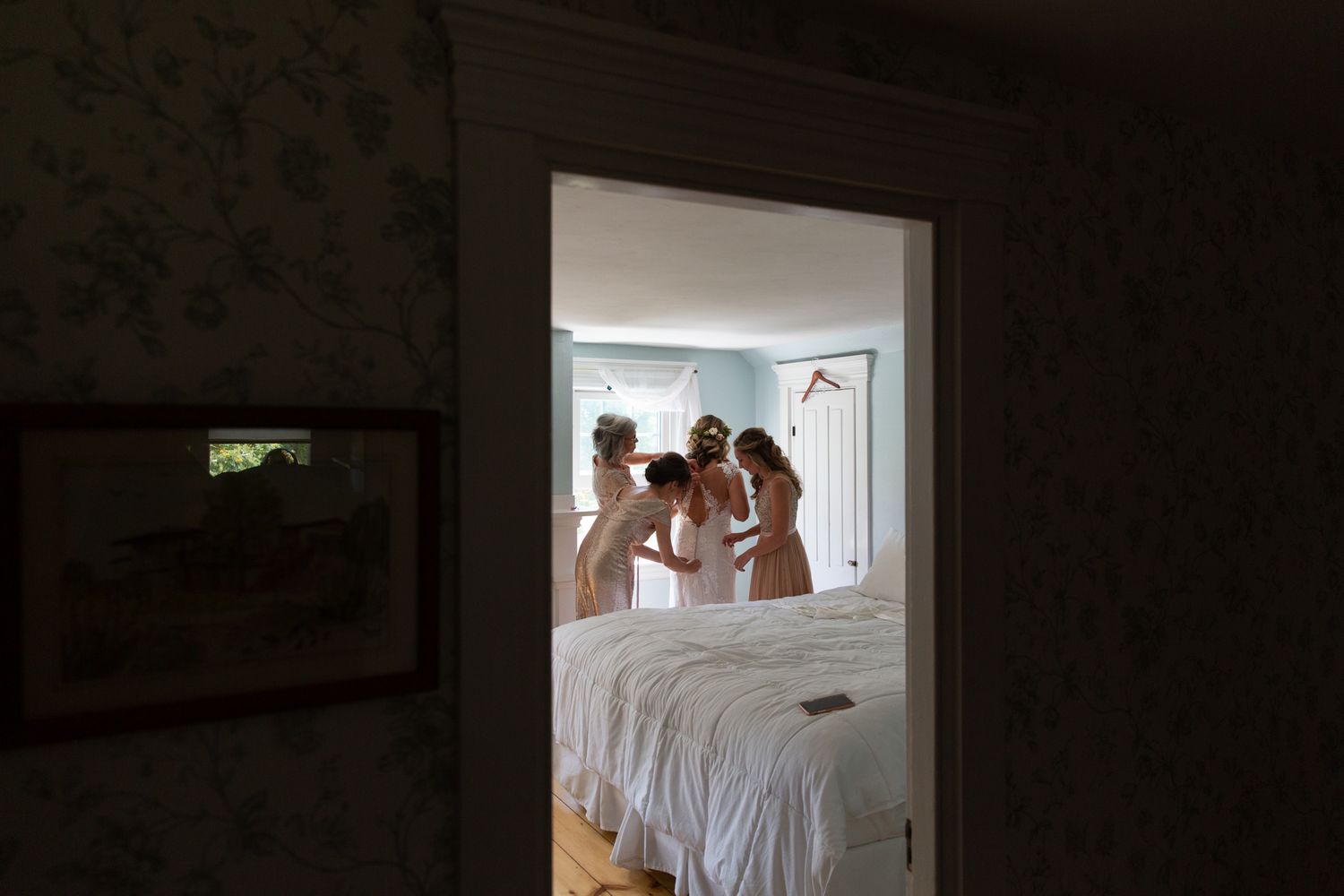 Silhouettes visible through doorways in a dimly lit interior space.