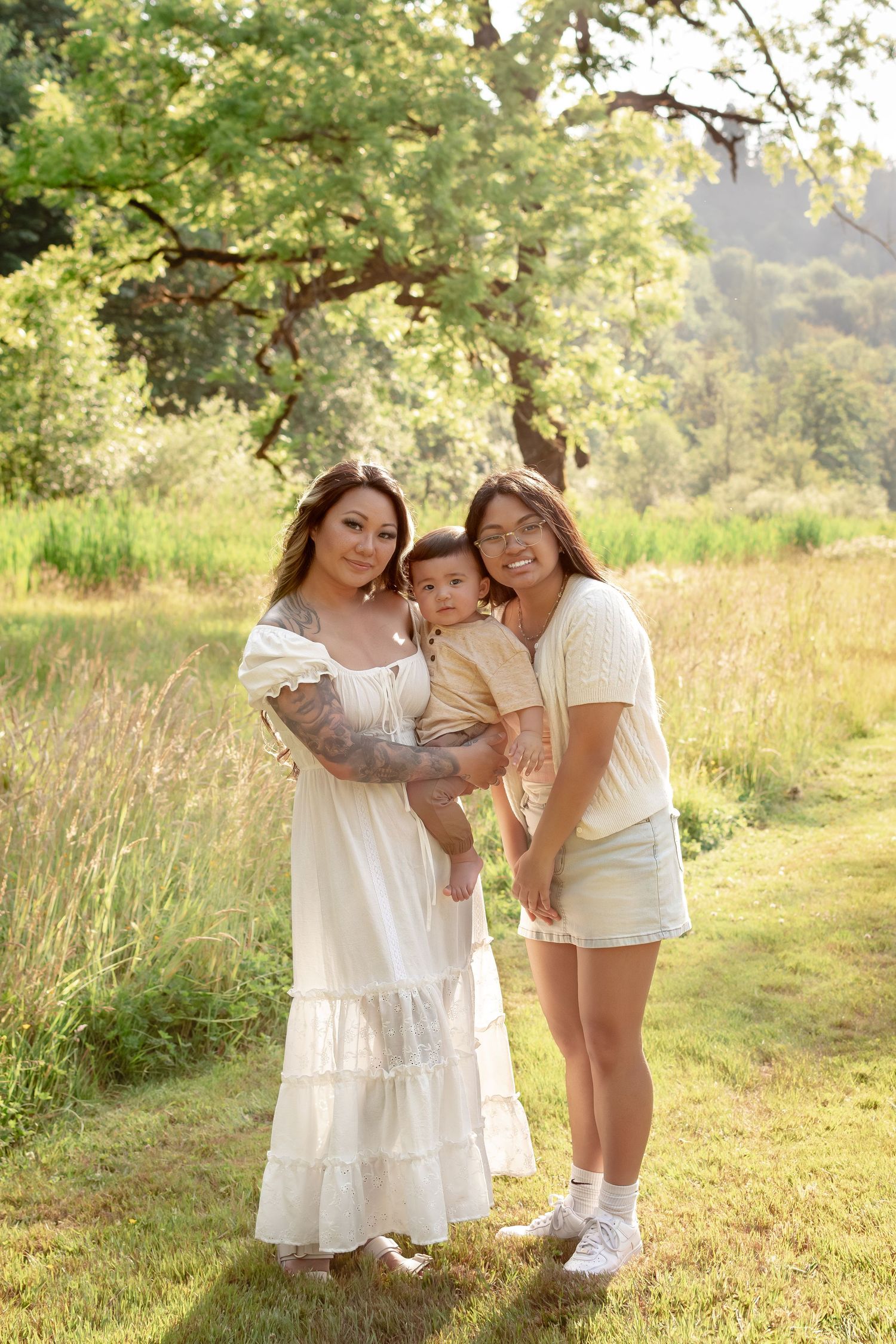 Teen daughter joining mother and baby during family photos at Flaming Geyser State Park