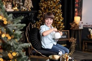 Cozy Christmas scene with a decorated tree and warm glowing lights in a living room setting.