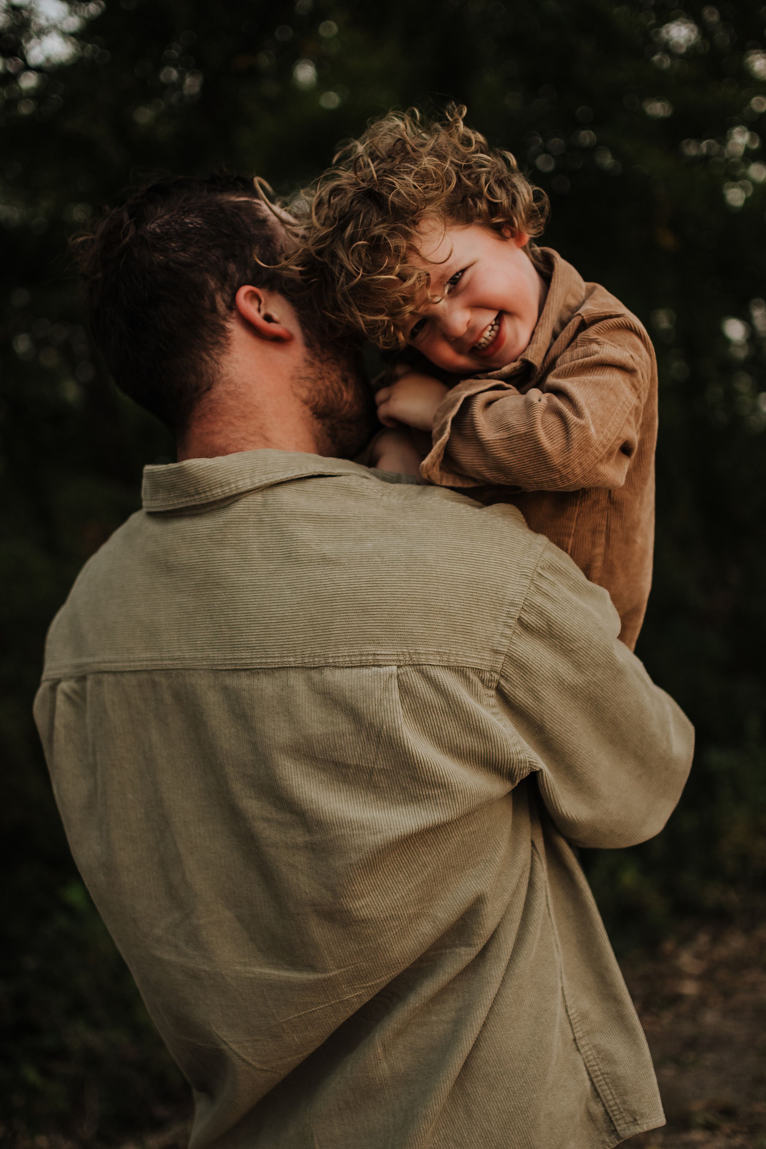 Heartwarming moment of joy and laughter during an outdoor embrace.
