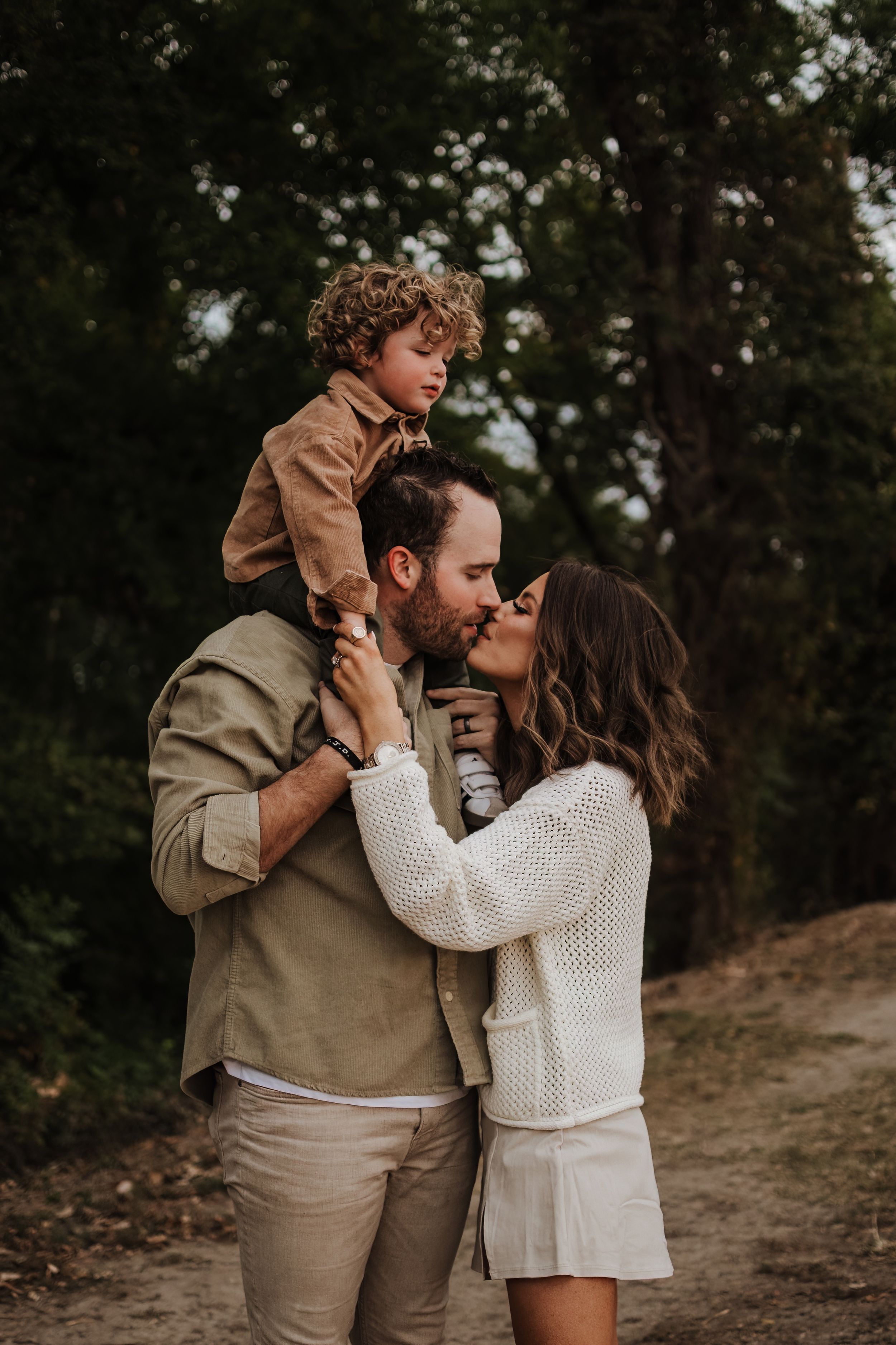 Intimate family moment captured during sunset on a nature trail.