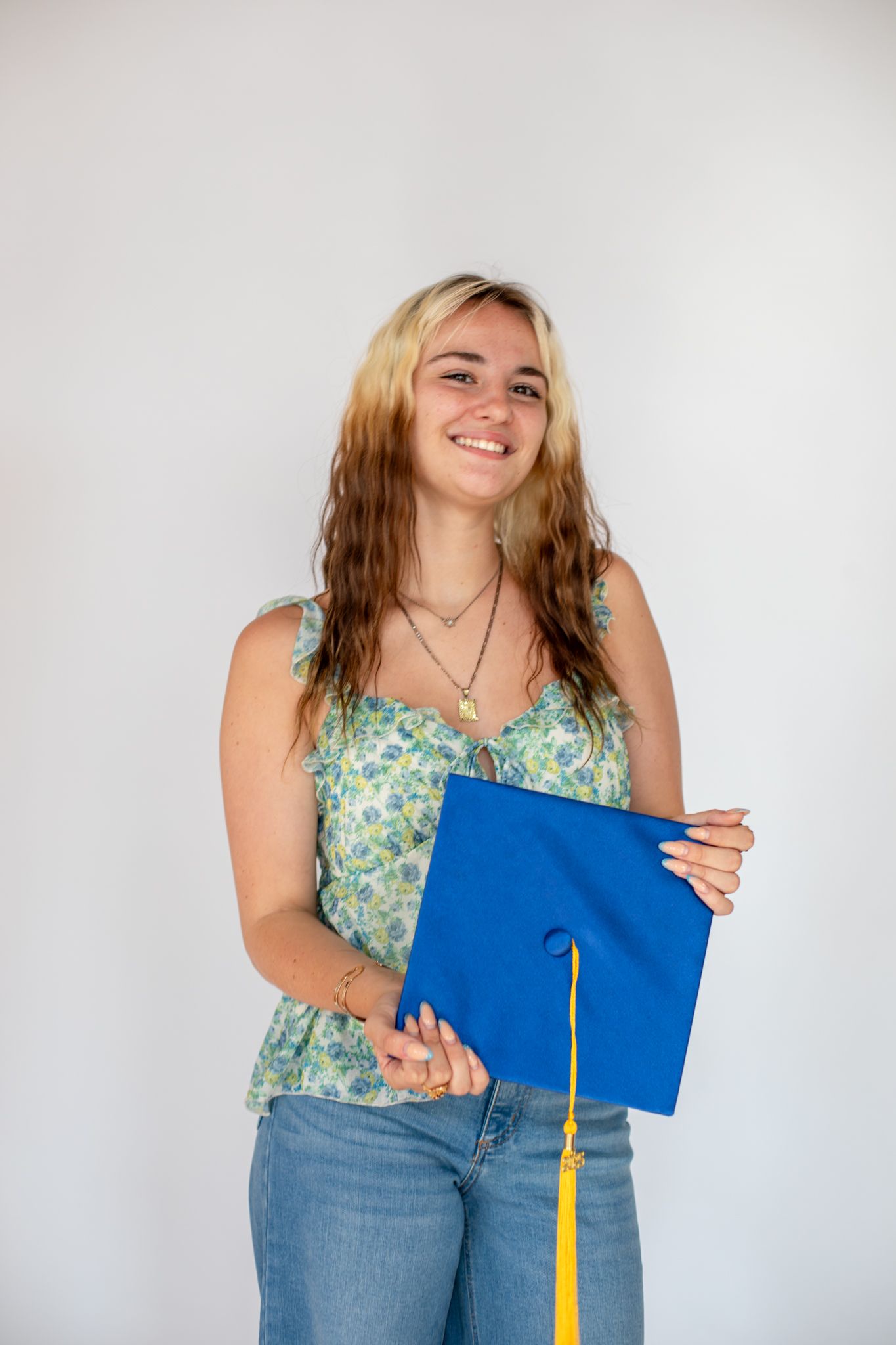 Graduate photo in Cincinnati studio with cap and gown for luxury senior portrait clients