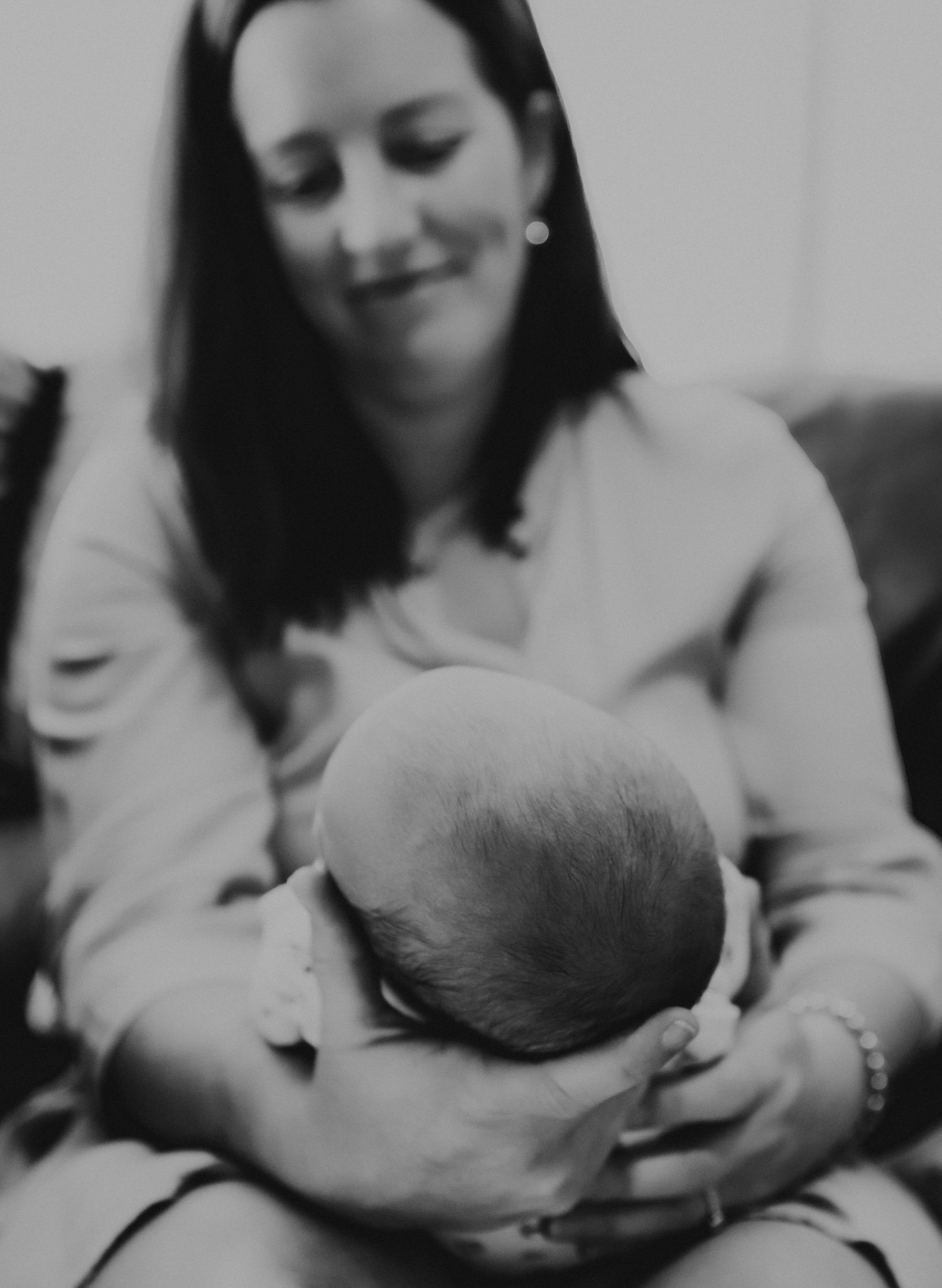 A series of black and white images showing tender moments of nursing and maternal care.