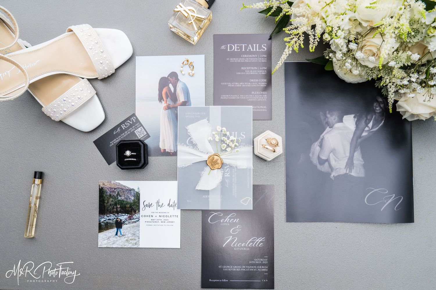 Elegant wedding stationery flatlay with invitation suite, shoes, ring box, and white floral bouquet.