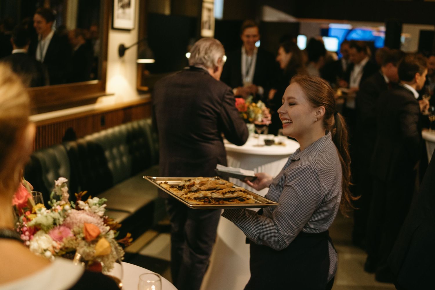 a waiter serving food during event at Nobel Prize Museum in Stockholm while being captured by event photographer