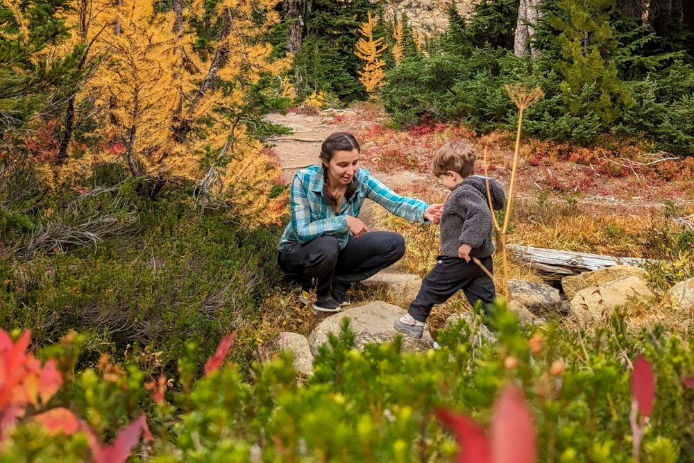 Mom helping son cross stream