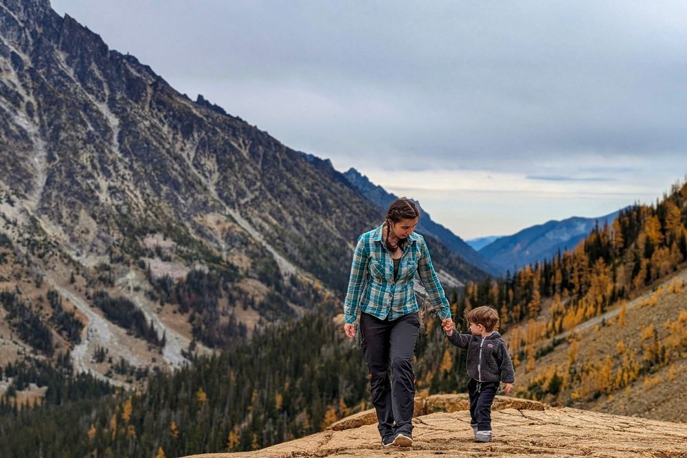 Mom walking son in front of mountain