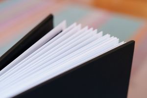 Close-up view of white pages bound in black hardcover album.