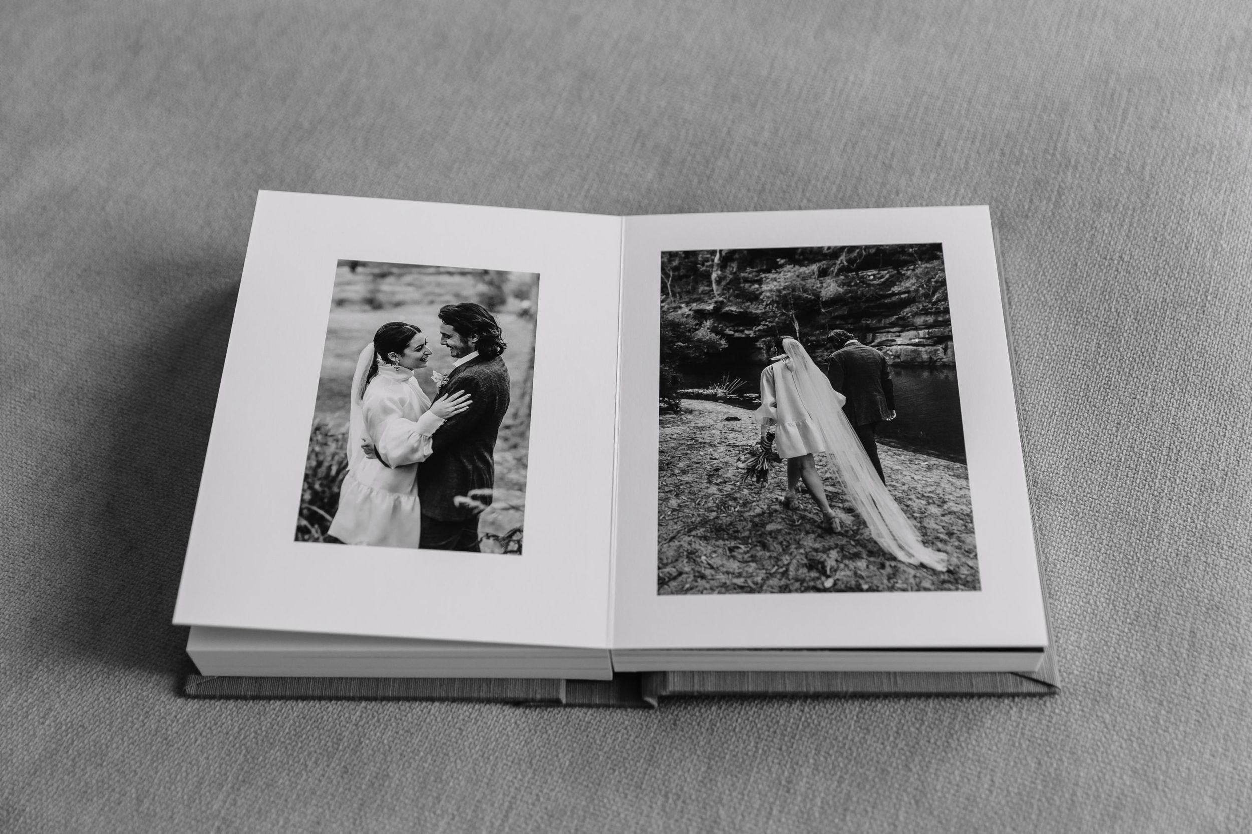 Black and white wedding album spread showing intimate couple portraits.