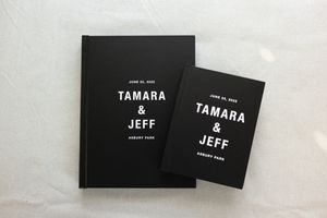 Modern black wedding album cover with minimalist typography design.