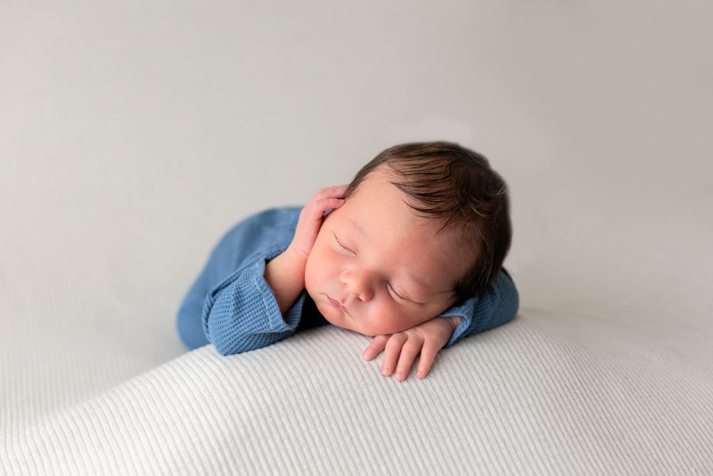 A sleeping baby wearing blue, Orlando Newborn Photography, Sanford Newborn Photography, How to put your newborn to sleep