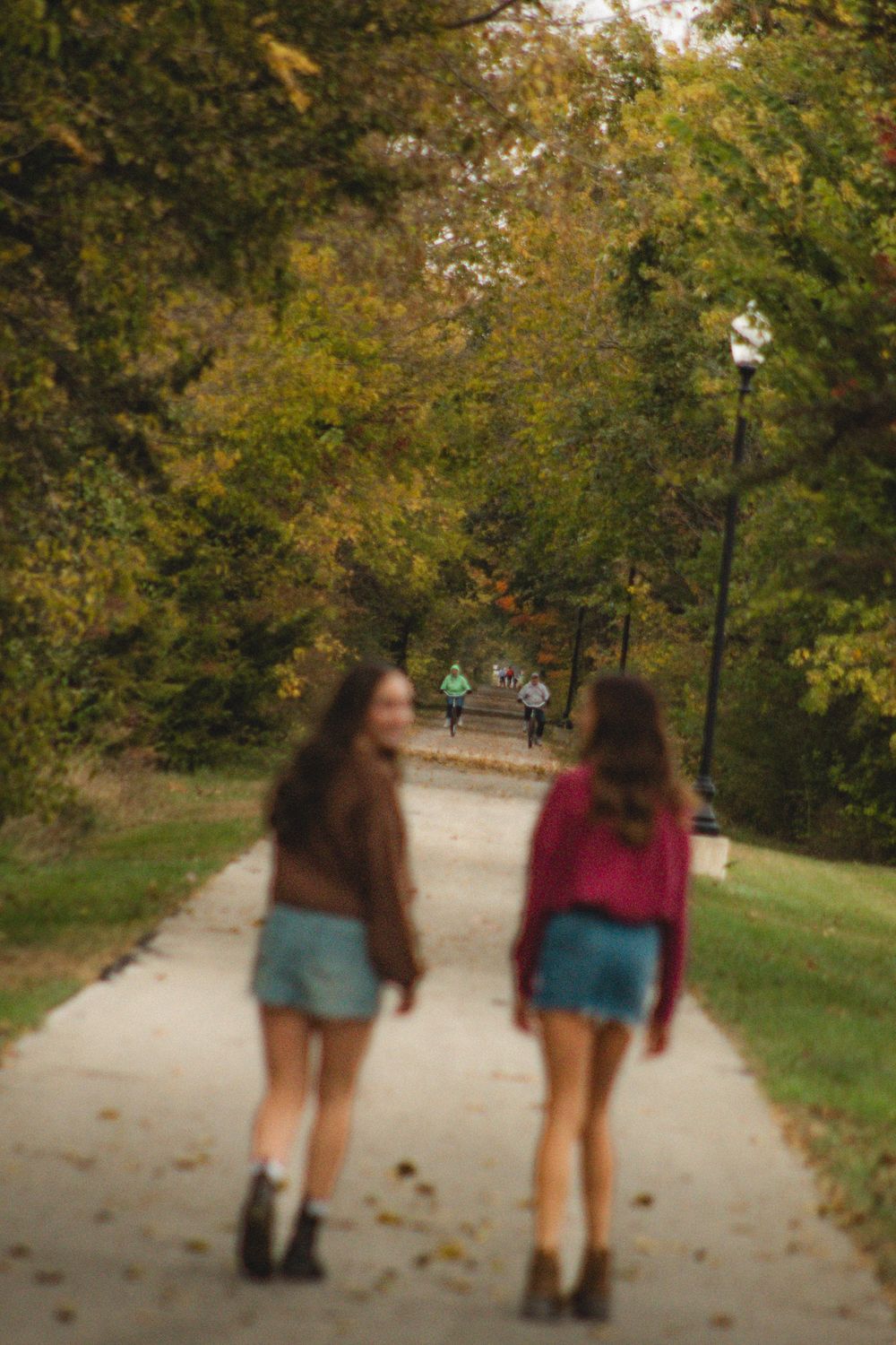 two friends walking down a sidewalk