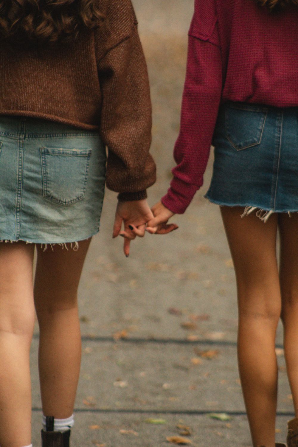 two friends locking pinkies, like a lifetime pinky promise.