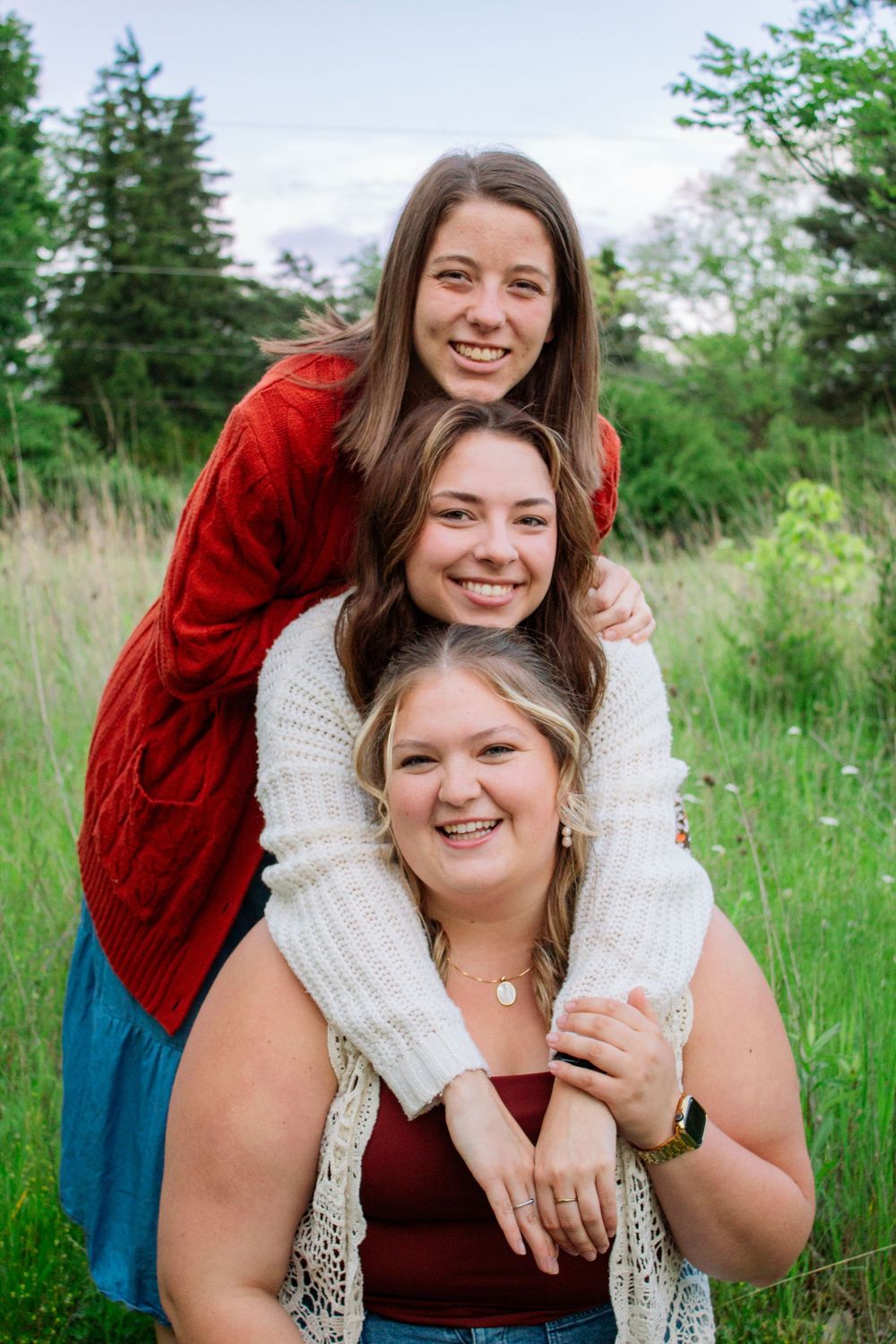 three friends stacking their heads above one another
