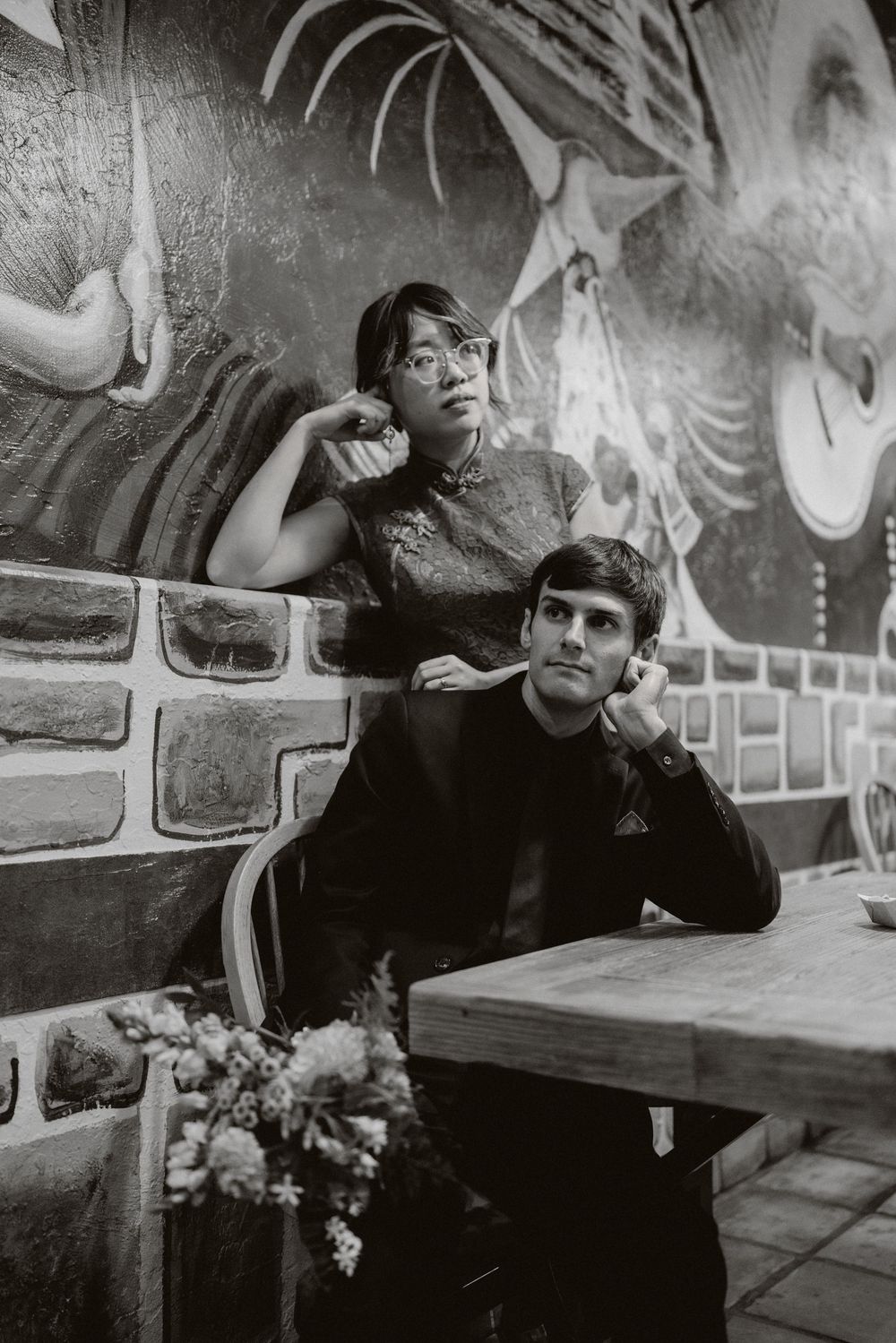 A series of black and white photos showing someone smoking and reclining in a casual indoor setting.