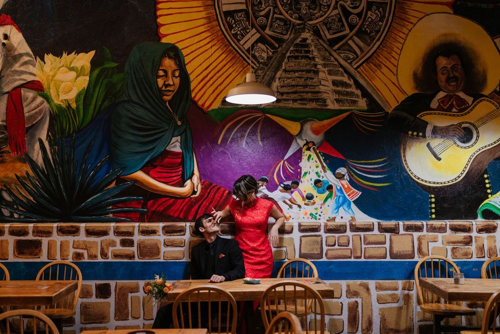 Colorful wall mural artwork featuring vibrant designs and patterns in a restaurant or cafe setting.
