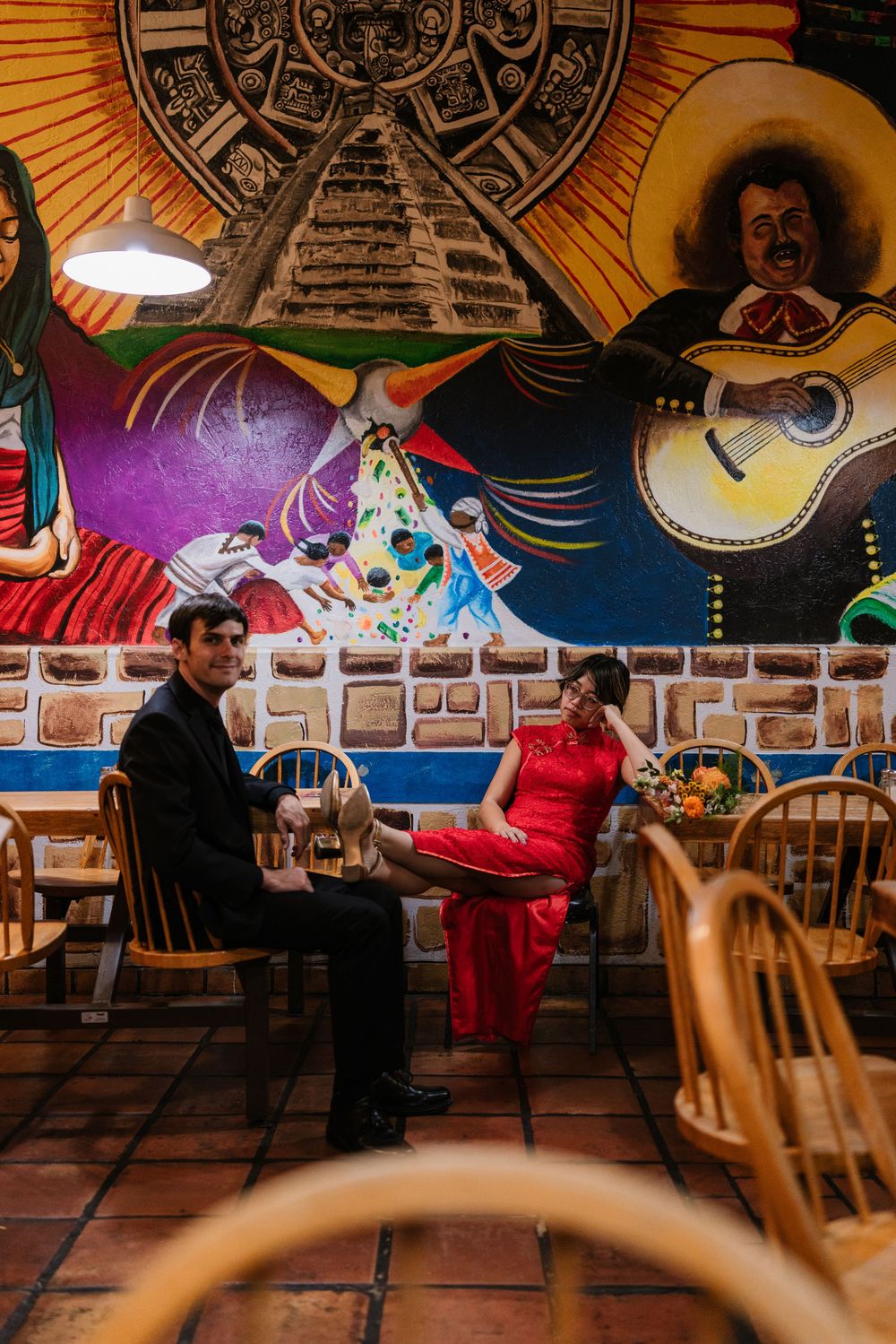 Sequence of dance moves shown on terracotta tiles with colorful wall murals and wooden chairs in a restaurant setting.