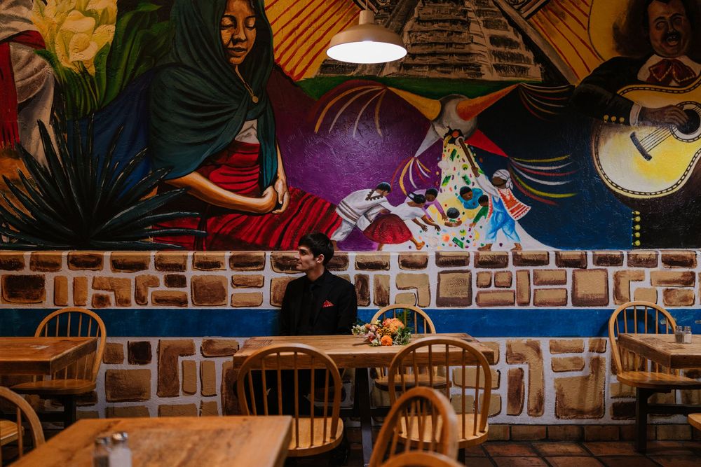 A colorful mural depicting vibrant street art and graffiti style designs adorns a wall in an urban setting.