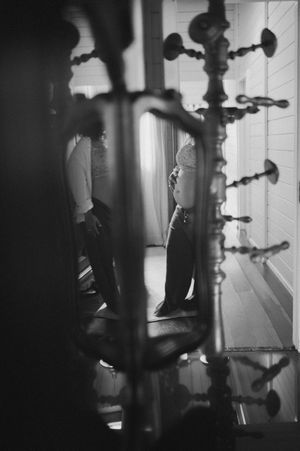 Black and white photos show silhouettes of figures in a dimly lit hallway with industrial pipes and fixtures.