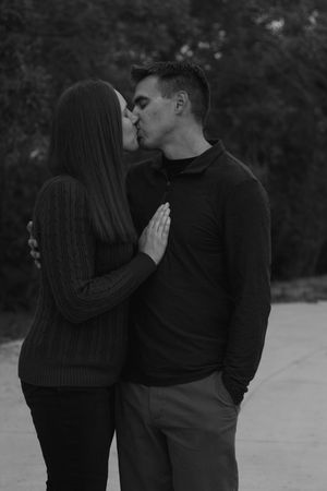A romantic couple in dark sweaters share tender moments black and white photography. | Motherhood + Family Photographer Westminster, CO