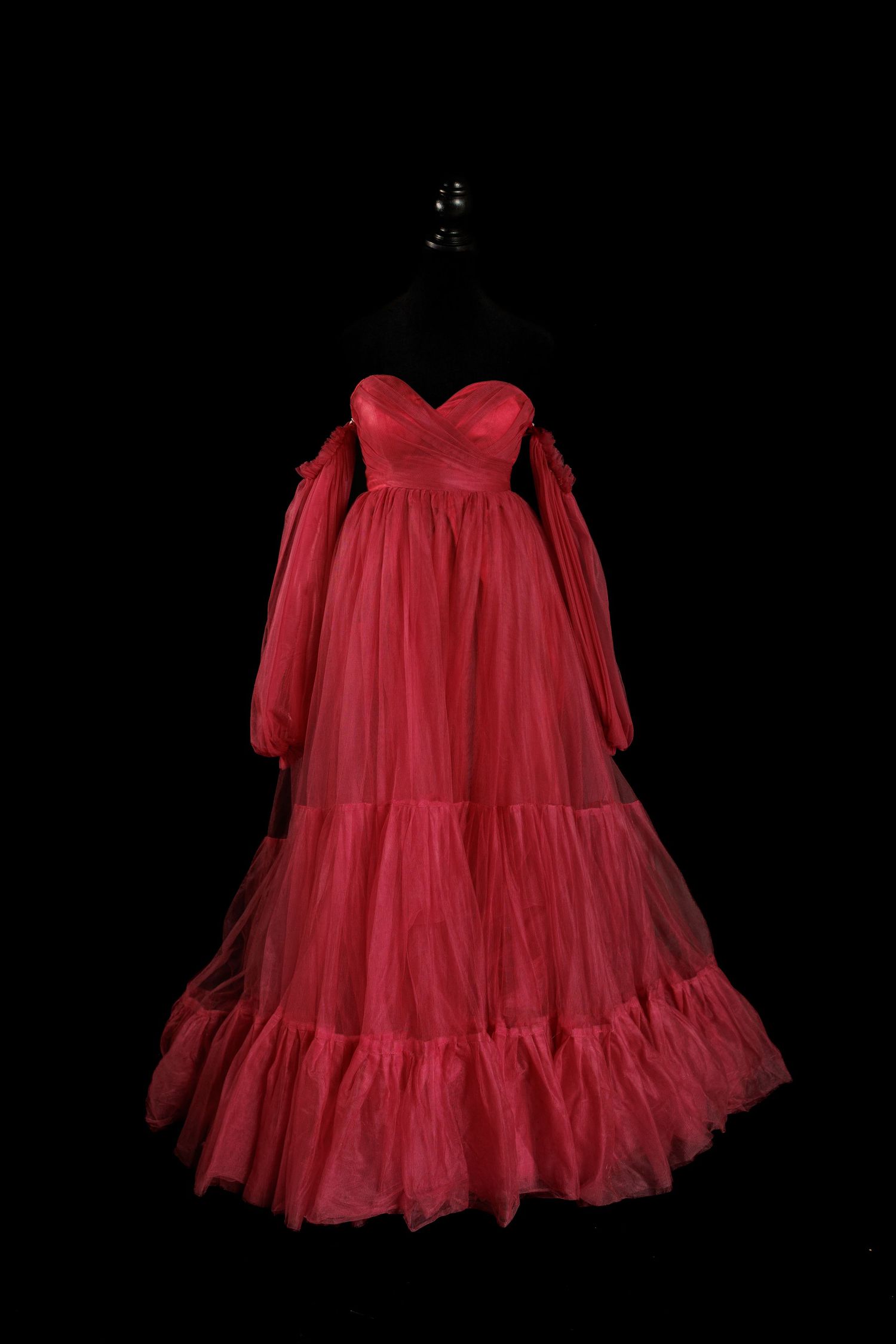 Deep red maternity gown with sweetheart neckline, long sheer tulle sleeves, and layered tulle skirt