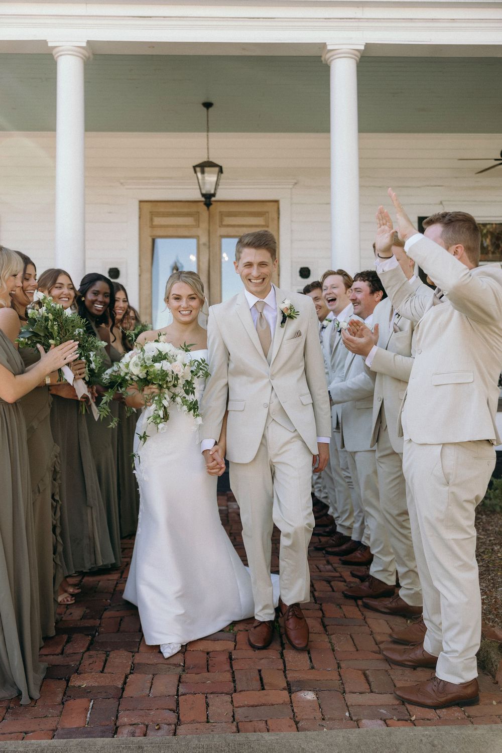Wedding party celebrates on brick patio with bridesmaids and groomsmen at Lillian Gardens in Newnan, Georgia