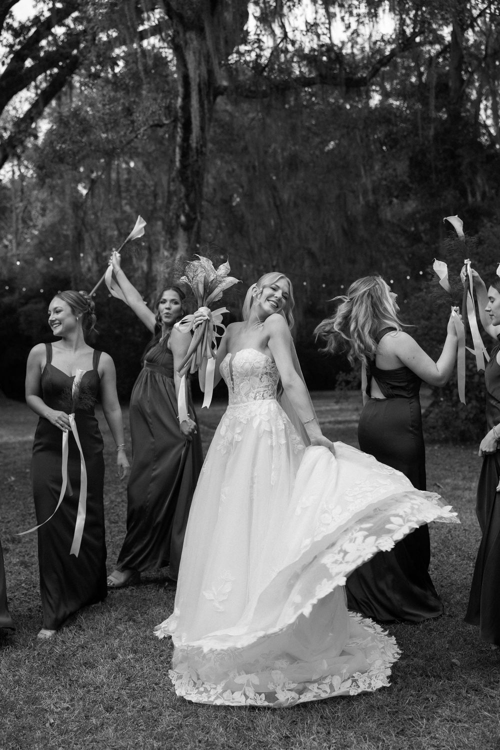 A black and white photo series shows a wedding party having fun with dramatic dance poses at The Elms of Coosada in Coosada, Alabama