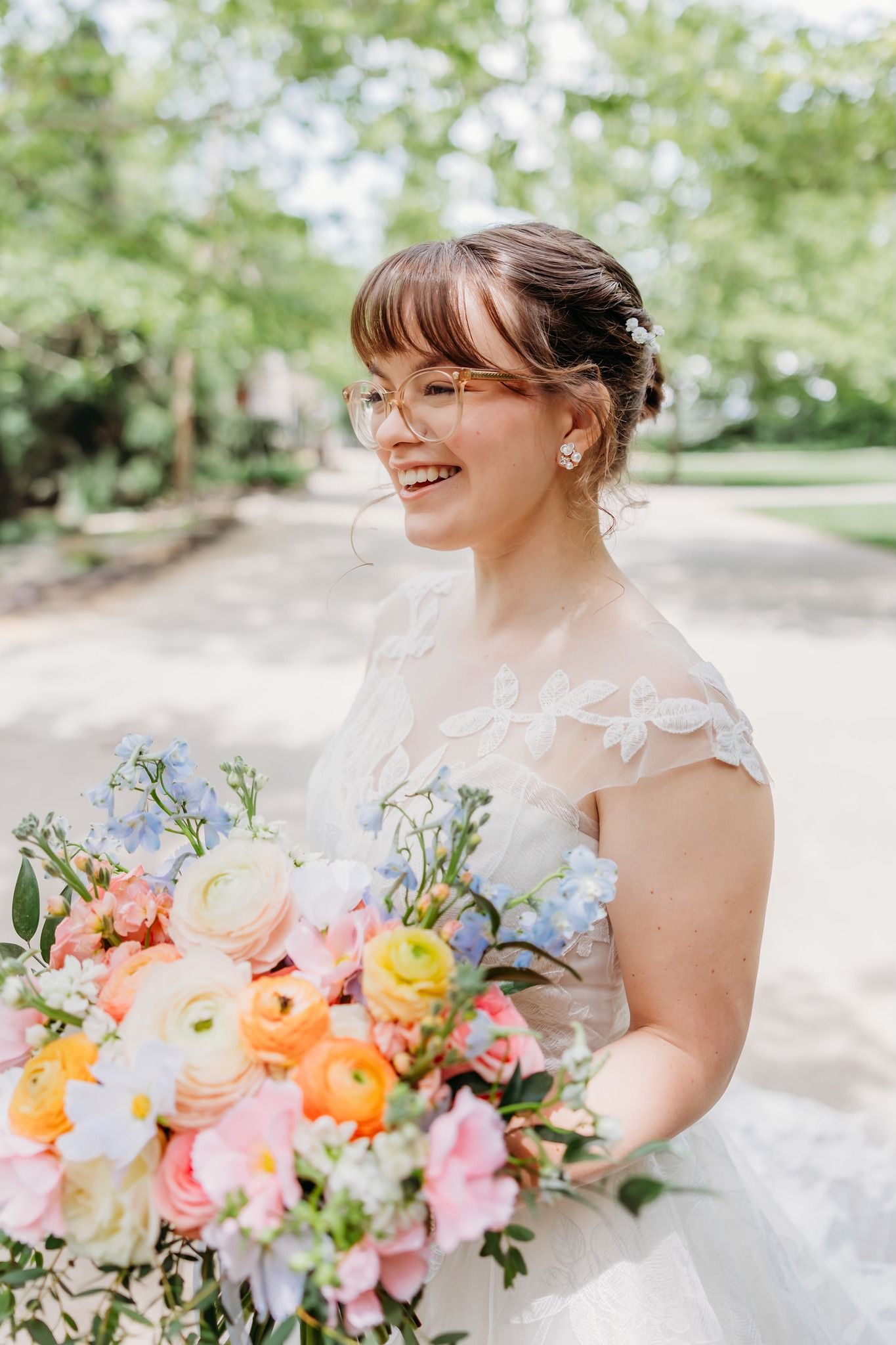 Joyful bride looking beautiful in her wedding dress. Spring inspired wedding bouquet at The Inn at Oneonta in Northern Kentucky.