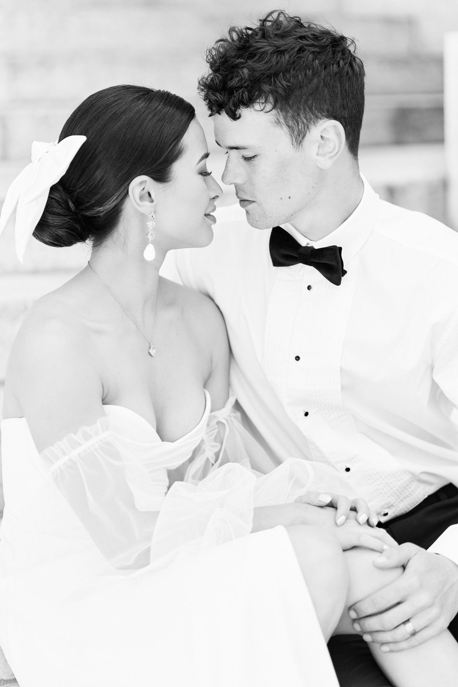 Beautiful black and whit portrait of a bride and groom sat outside The Petit Palais in Paris, France by fine art photographer Faye Amare