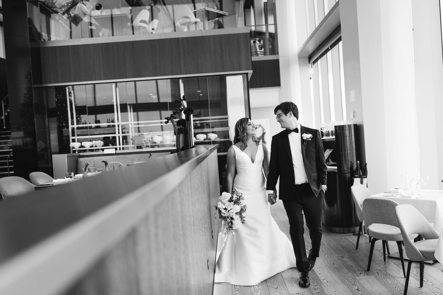 Black and white wedding photos showing romantic moments between bride and groom in an elegant indoor venue.