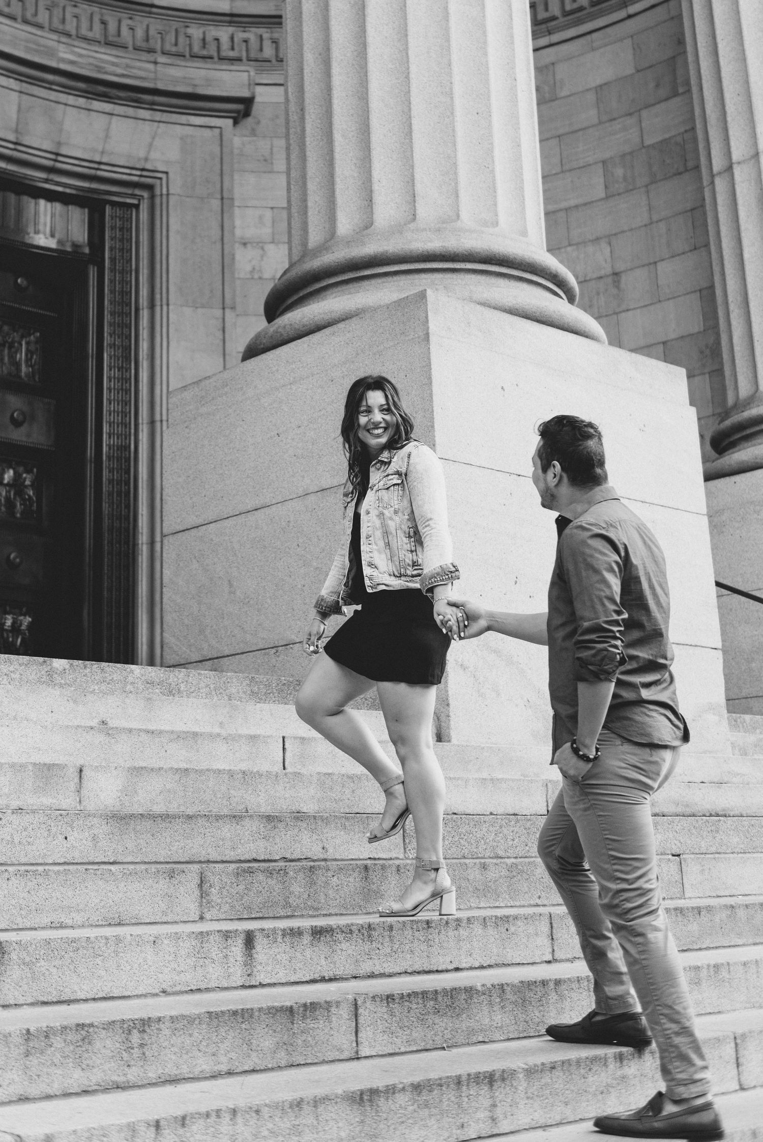 A sequence of black and white photos showing someone climbing stone steps outside a classical building.