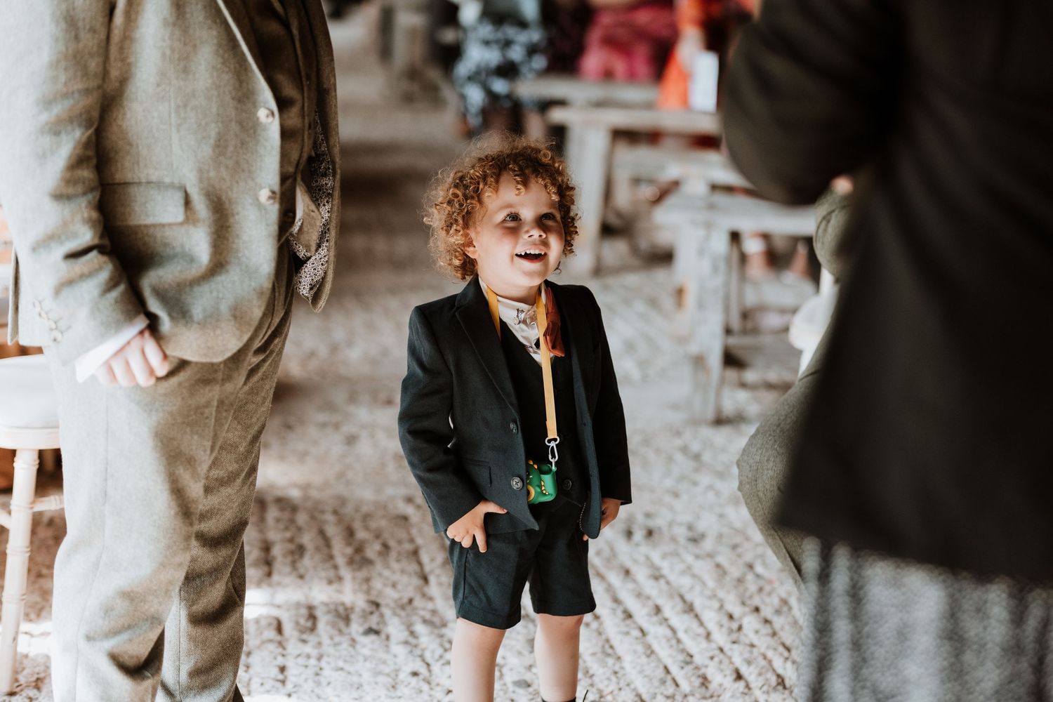 A toddler wearing a dark green jacket at wedding at Lyde Court, Hereford.