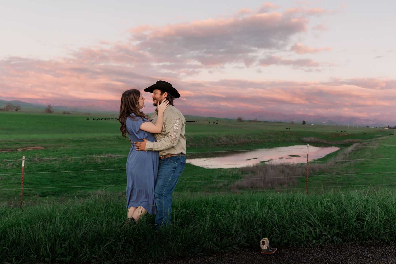 Couple embraces in a romantic moment at sunset across multiple scenic outdoor landscapes with green fields and mountains.