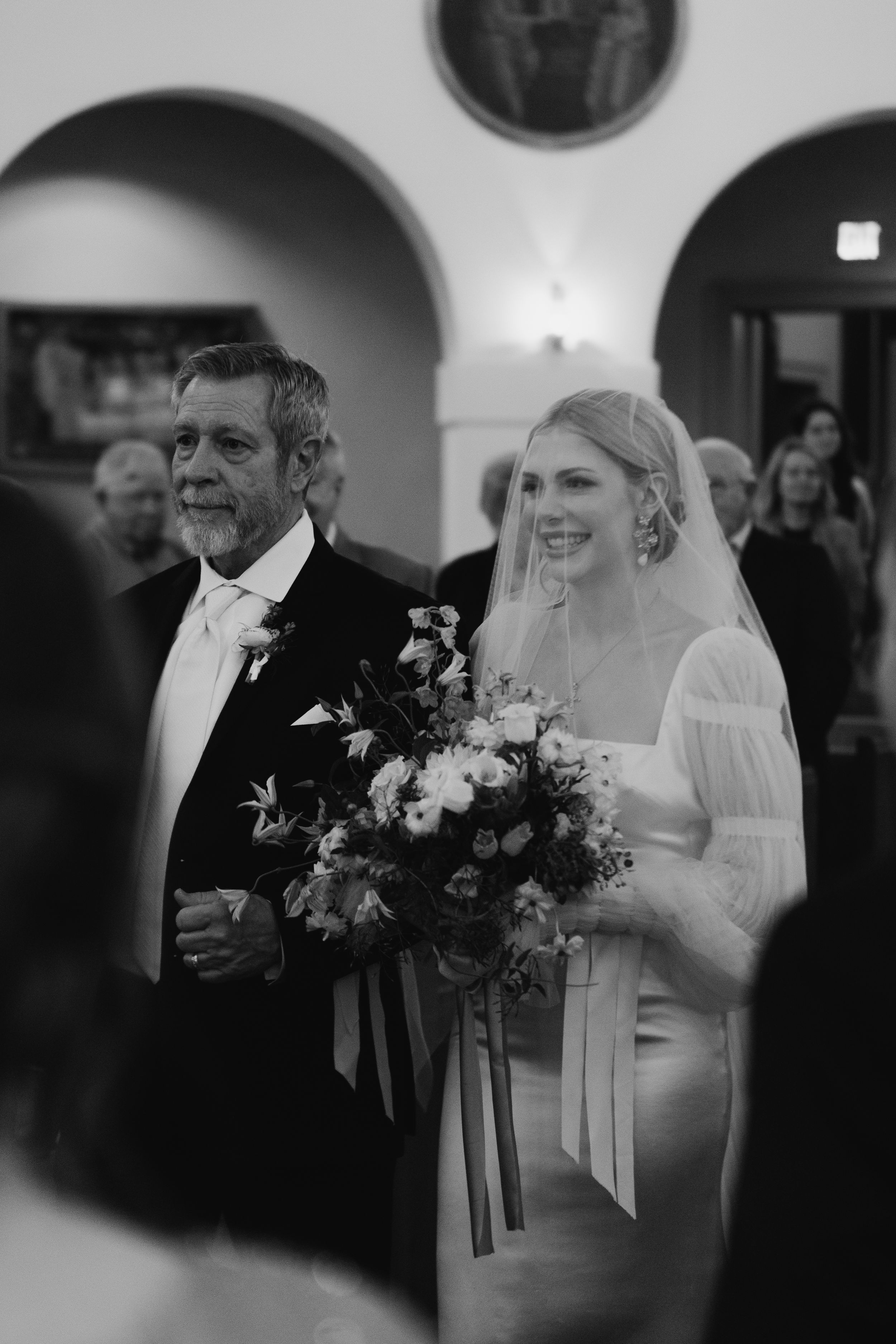 Black and white wedding photos showing tender moments during a ceremony with a bride in a veil and bouquet.