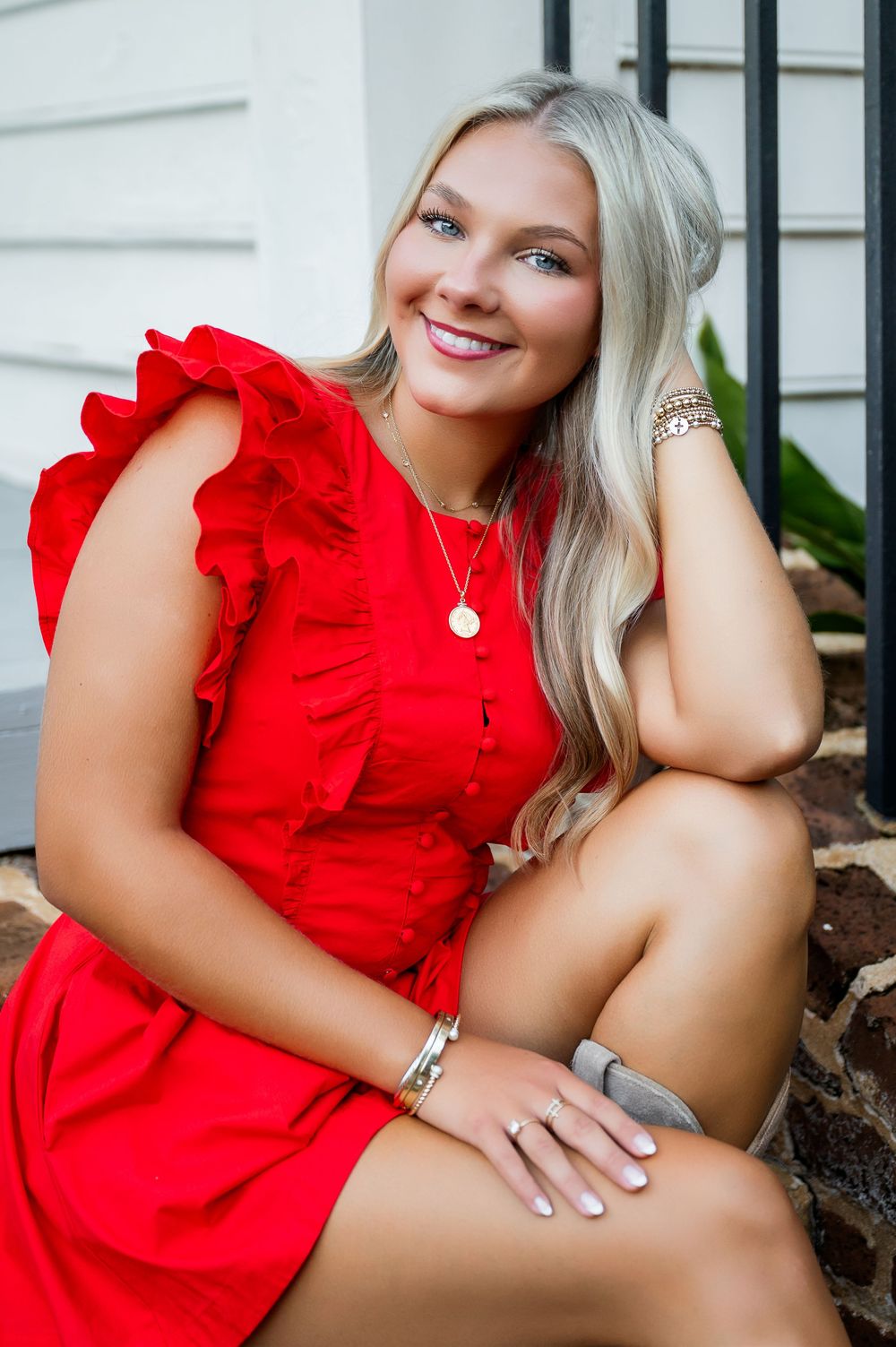 Red ruffled summer outfit photographed in an outdoor portrait session.