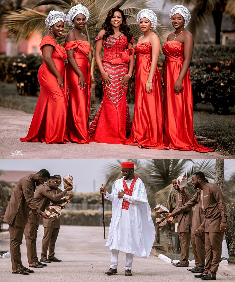 Wedding party wearing vibrant red dresses poses together while groomsmen in brown suits kneel in formation on pavement.