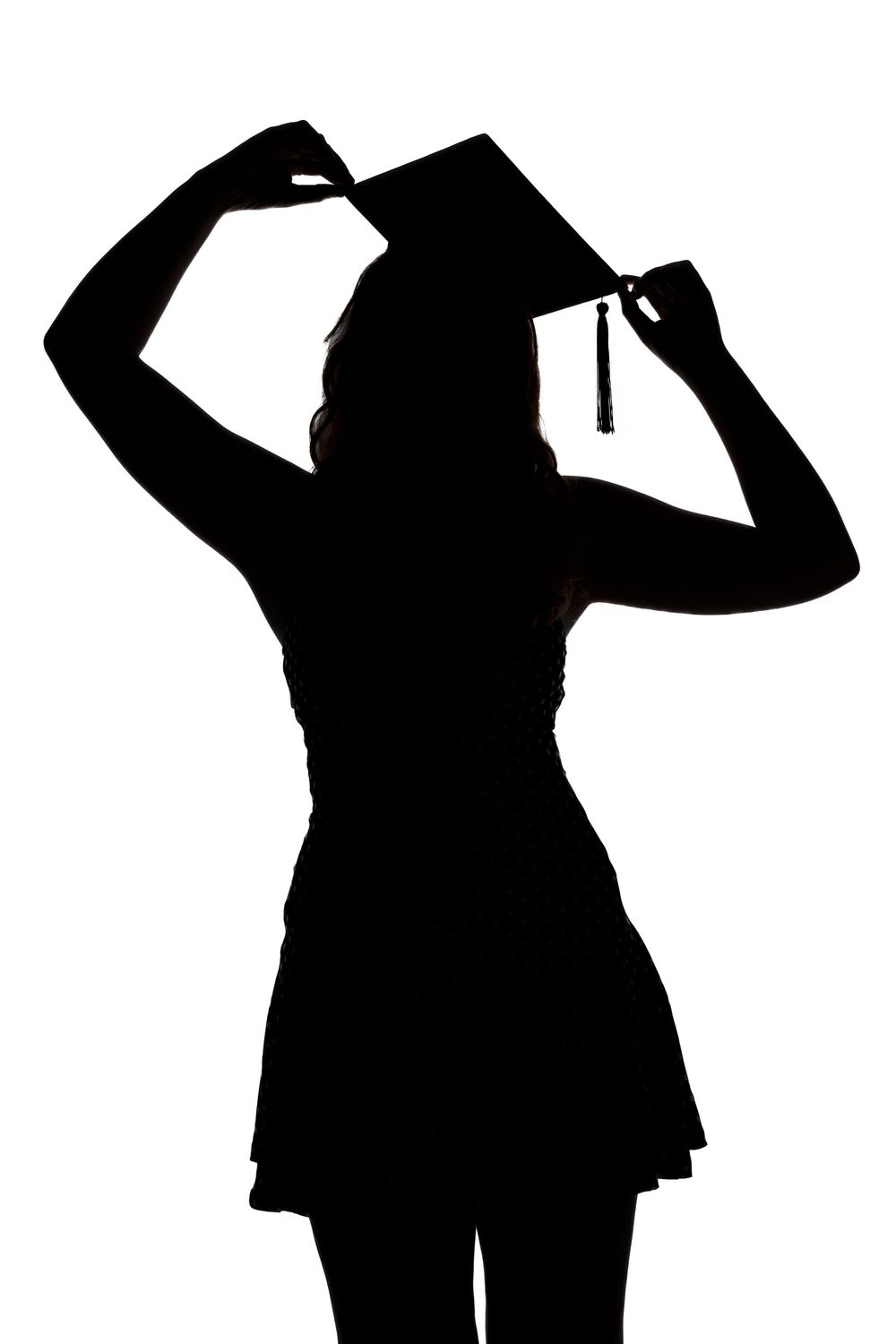 Silhouettes of people in business attire looking up and shielding their eyes while standing in a row.