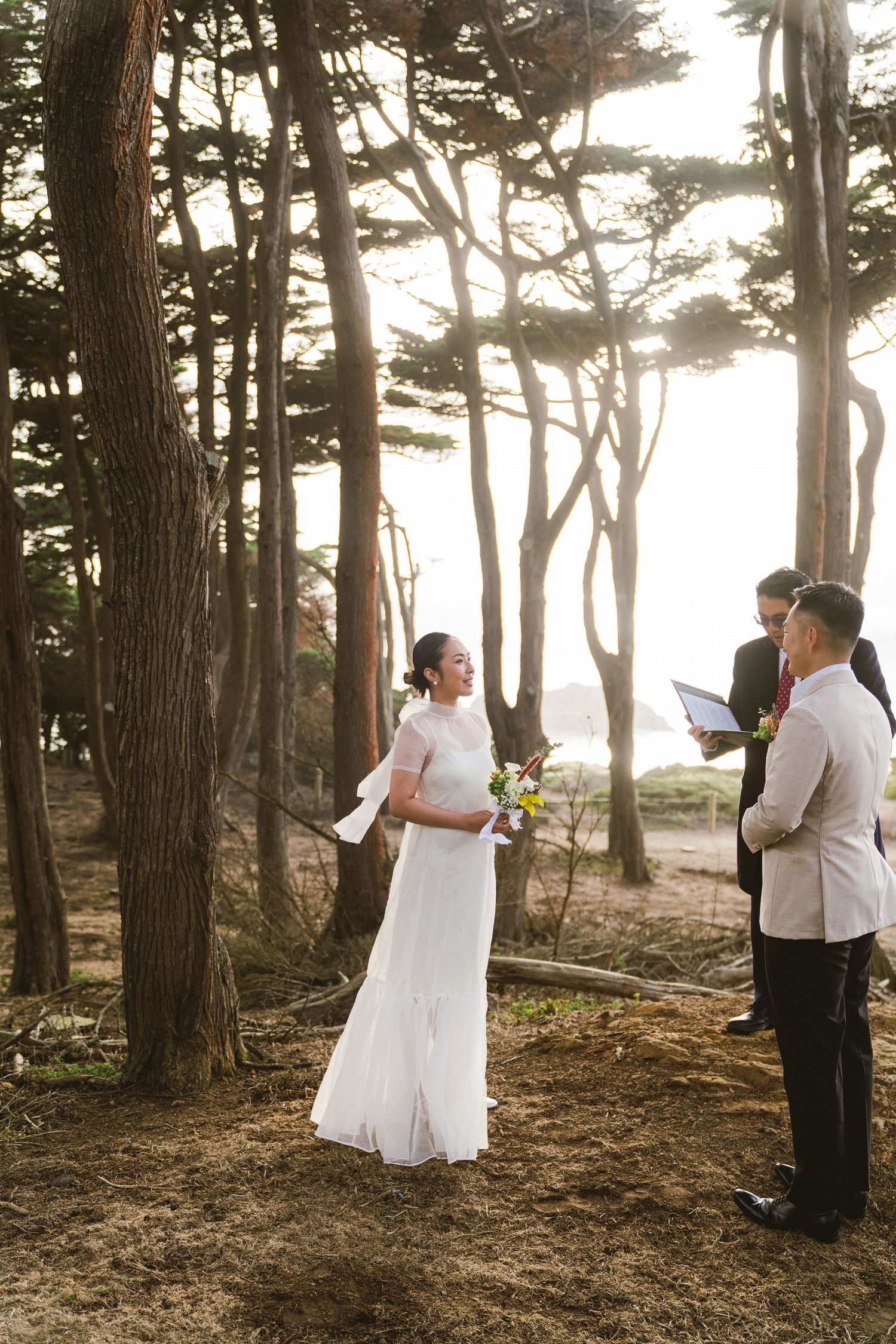 A romantic wedding photo sequence in a misty forest shows a couple in white and black formal attire among tall pine trees.