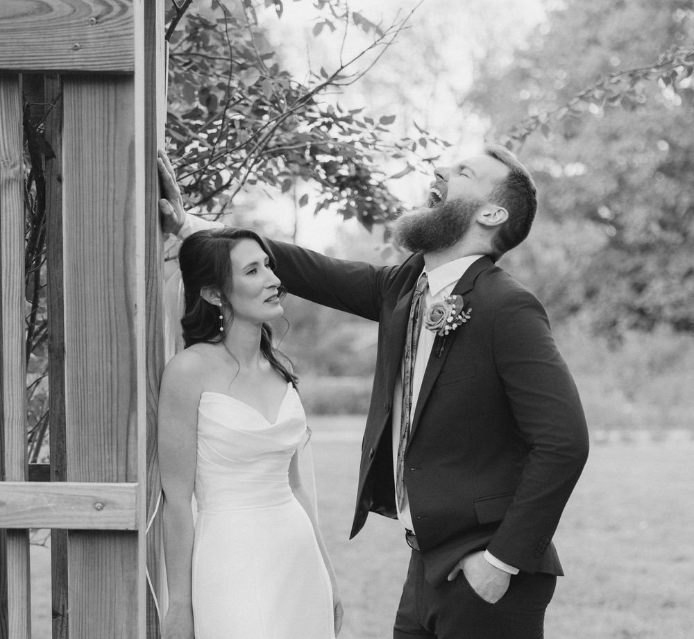 A black and white photo collage shows a couple sharing playful and romantic moments outdoors in a garden setting. park of roses columbus