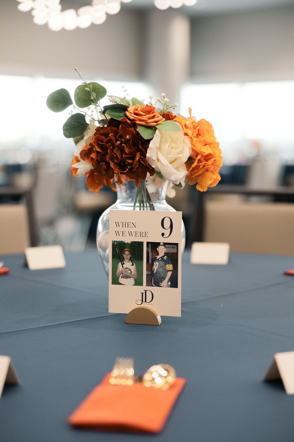 Wedding reception table centerpiece with orange and white roses bob crane community center wedding.