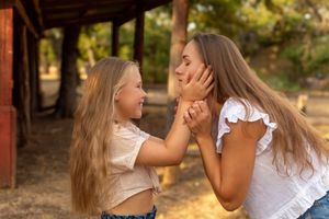 Two people share an intimate moment outdoors at sunset in a romantic setting. family session eagle mountain park fort worth texas