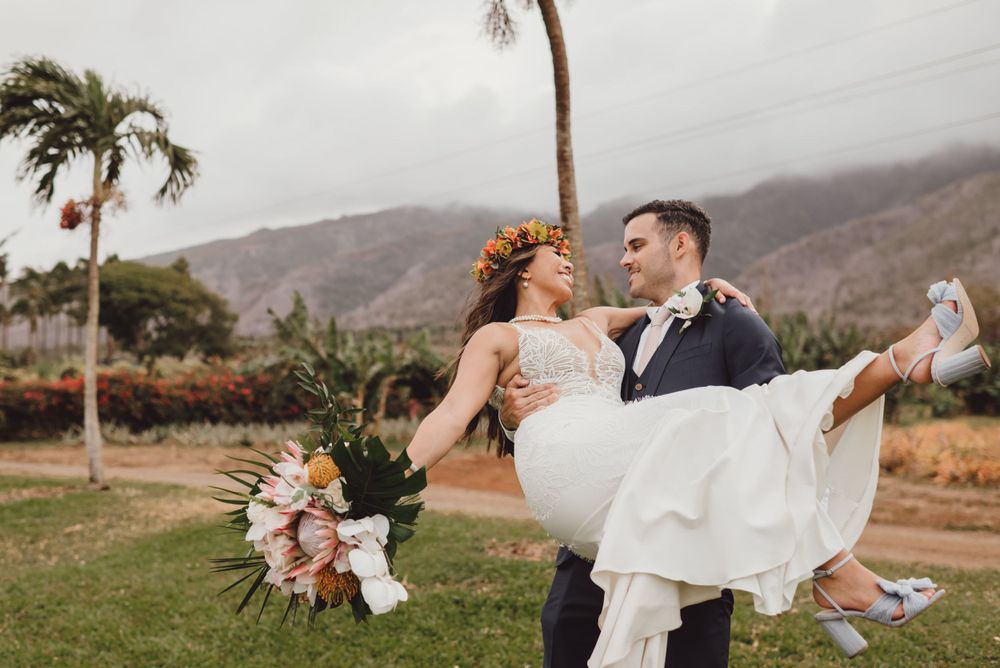 Elegant wedding photography session with mountain backdrop and palm trees.