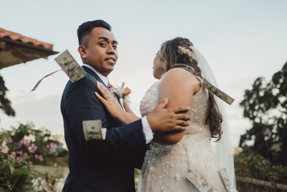 Wedding couple shares romantic moment during outdoor ceremony with mountain backdrop.