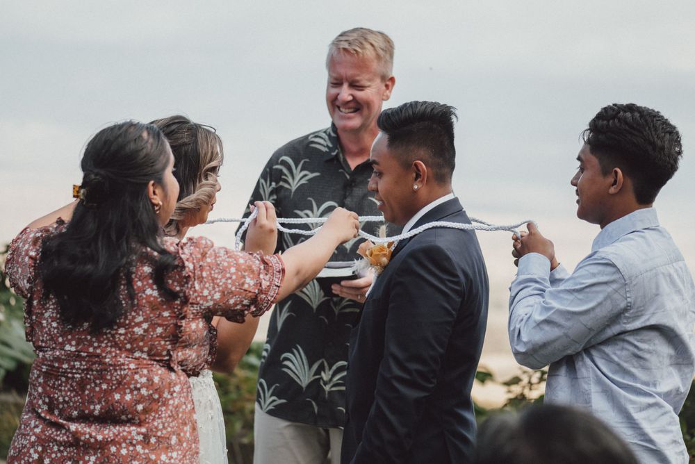 Wedding guests and officiant gather for a casual moment during the celebration.