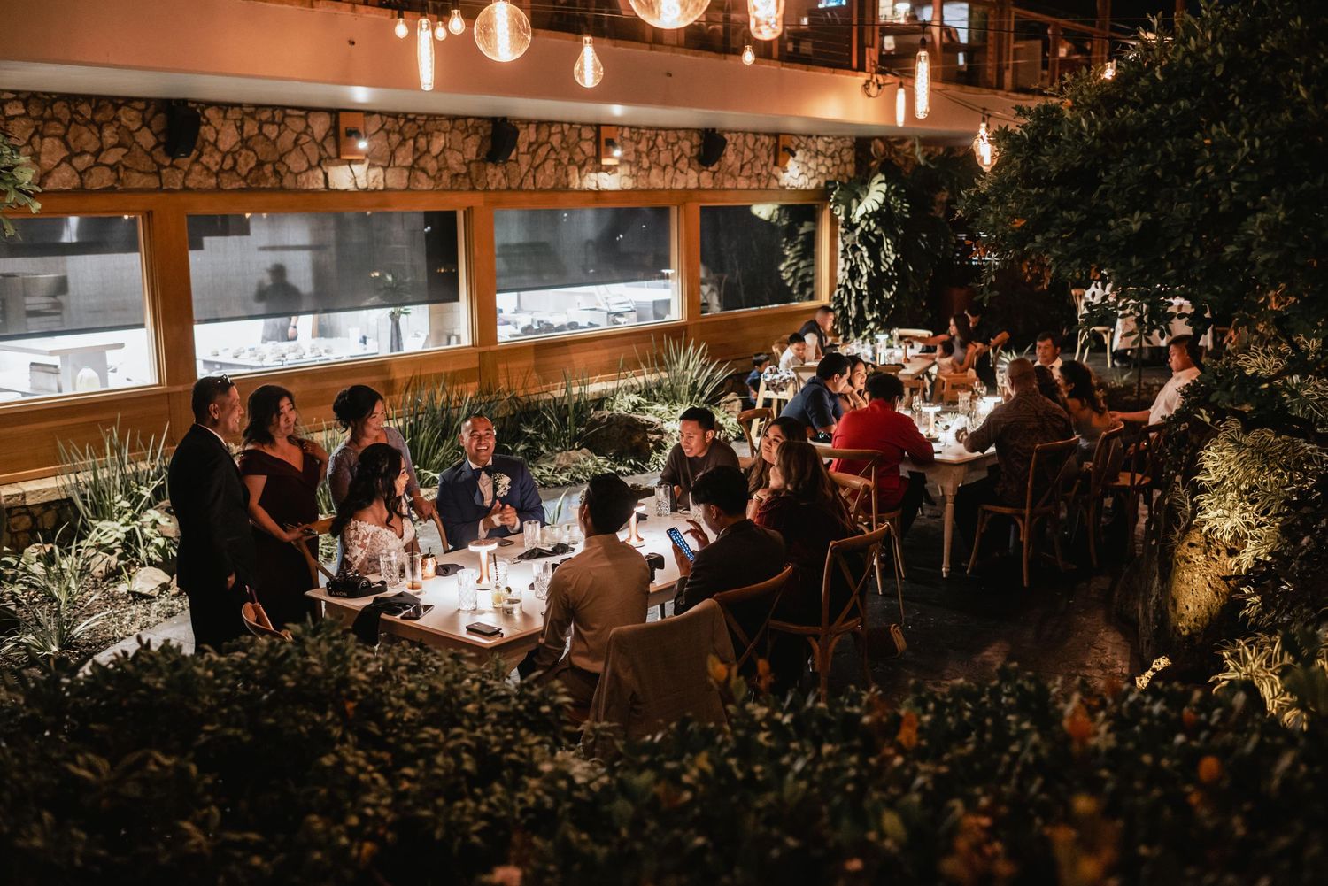Wedding reception venue with warm ambient lighting and tables set for dinner celebrations.