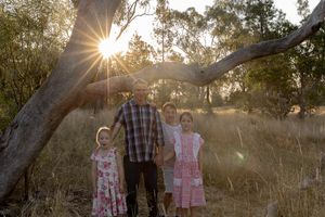 Family in a paddock at sunset during a professional family photo shoot