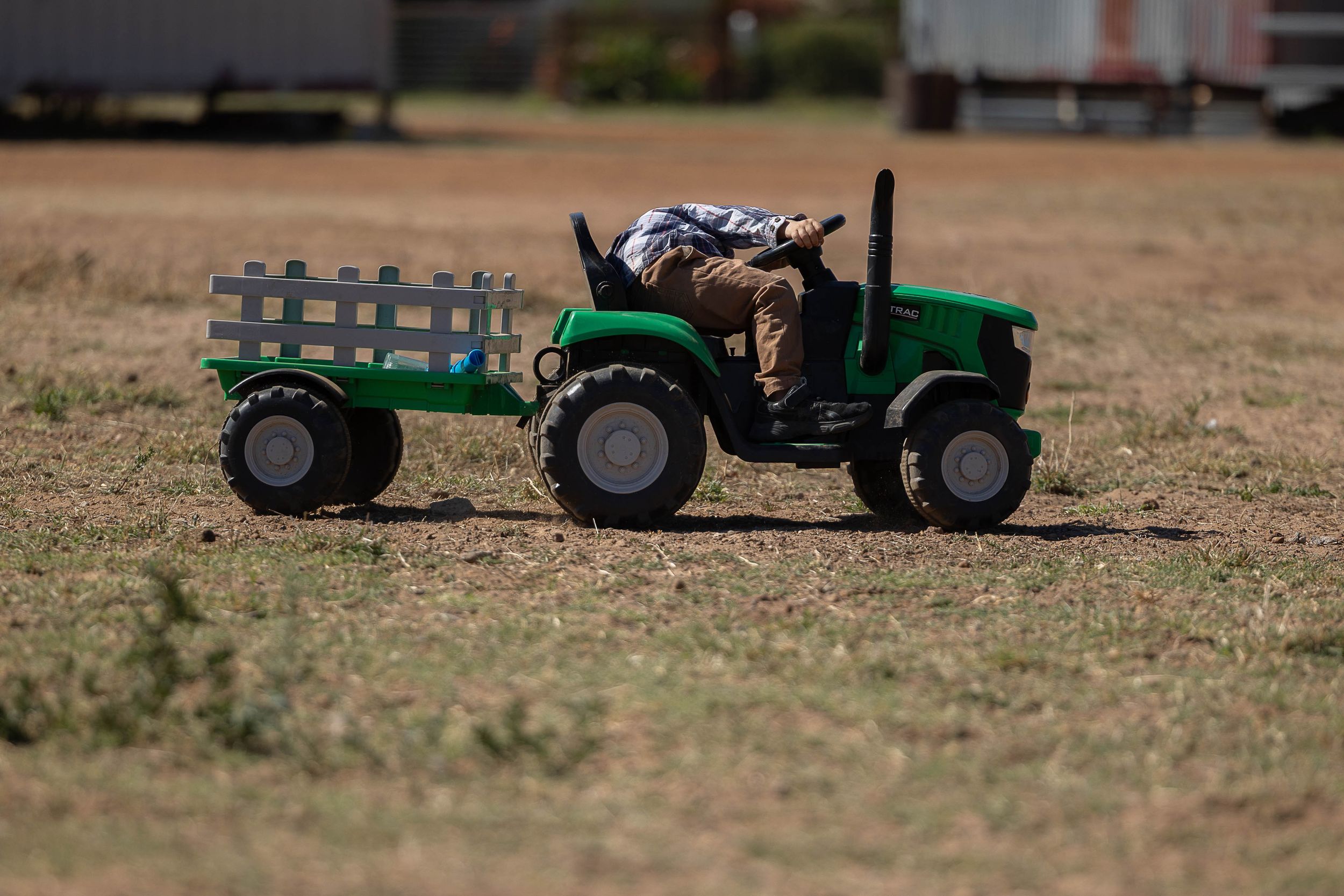 boy checking ride on tractor on country rustic farm