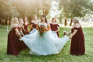 Wedding party in burgundy dresses and white gown pose together in Irrigon, Oregon wedding.