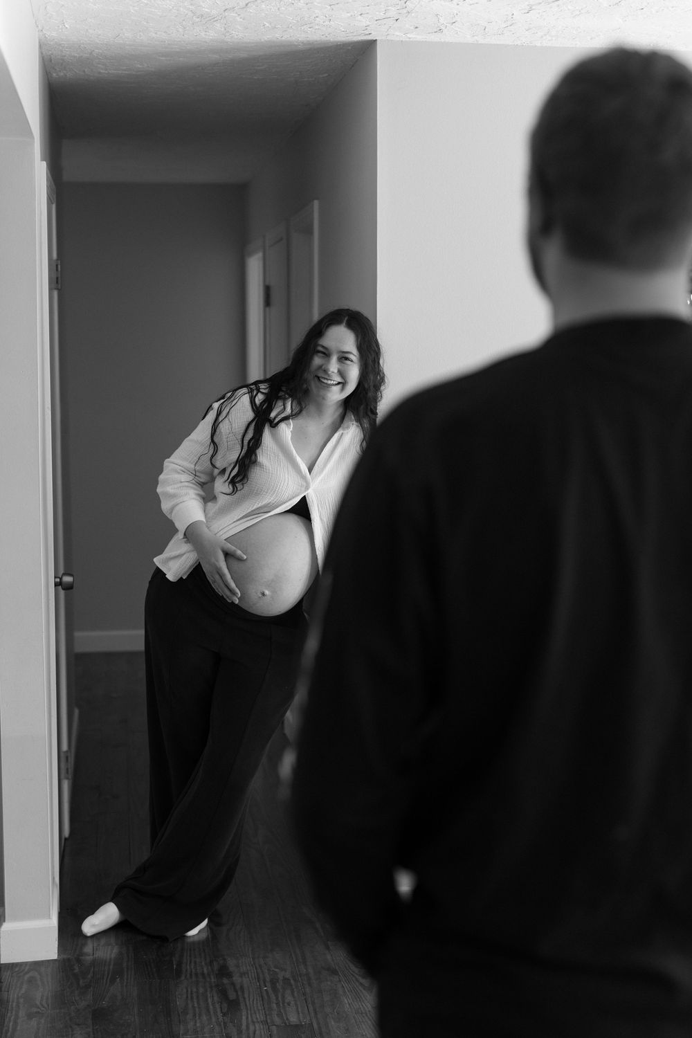 A series of black and white photographs showing people in an indoor setting with doorways and hallways.